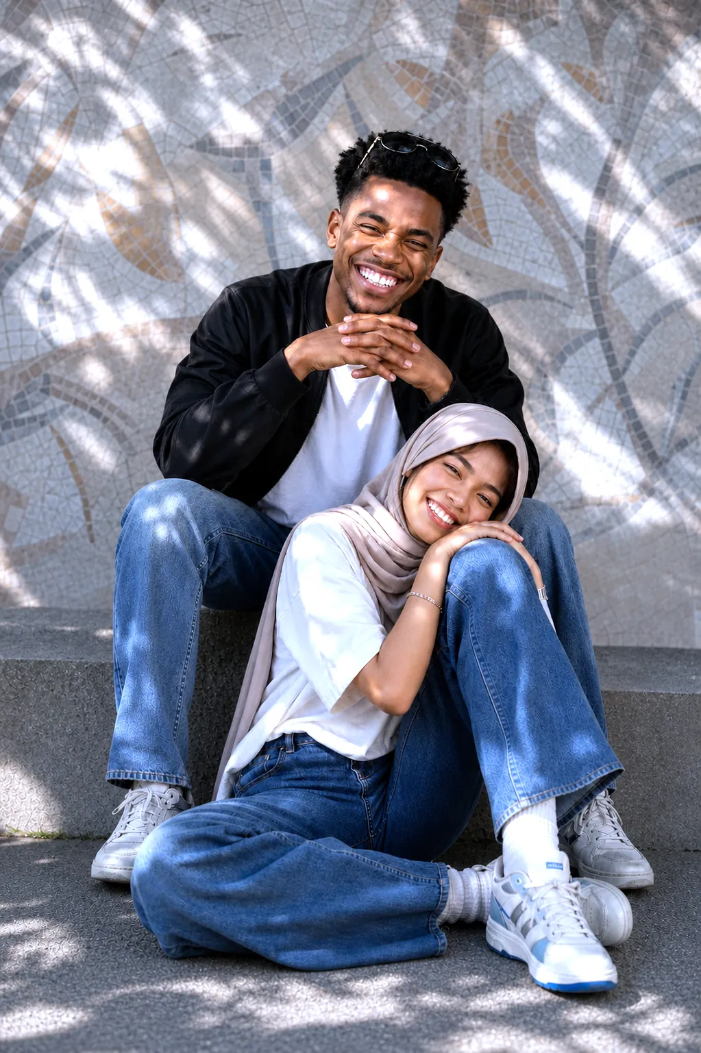 A smiling couple sitting on steps